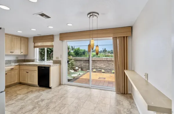 a large white kitchen with a large window
