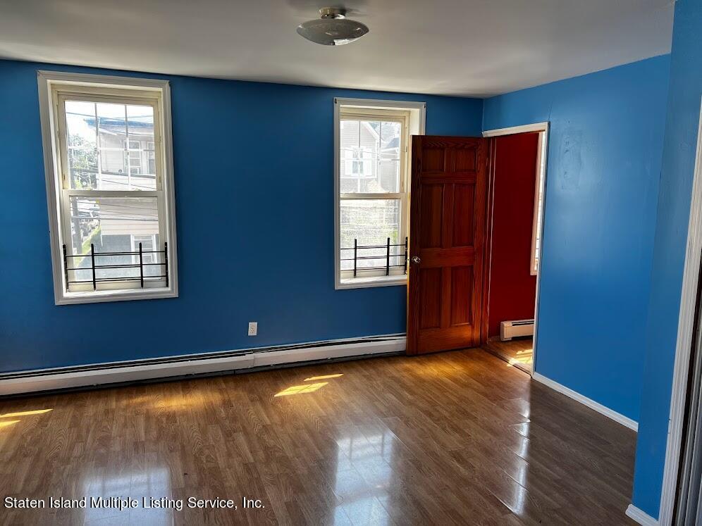 1641 Castleton Avenue Staten Island, NY 10302 - Photo 12 of 15 an empty room with wooden floor and windows