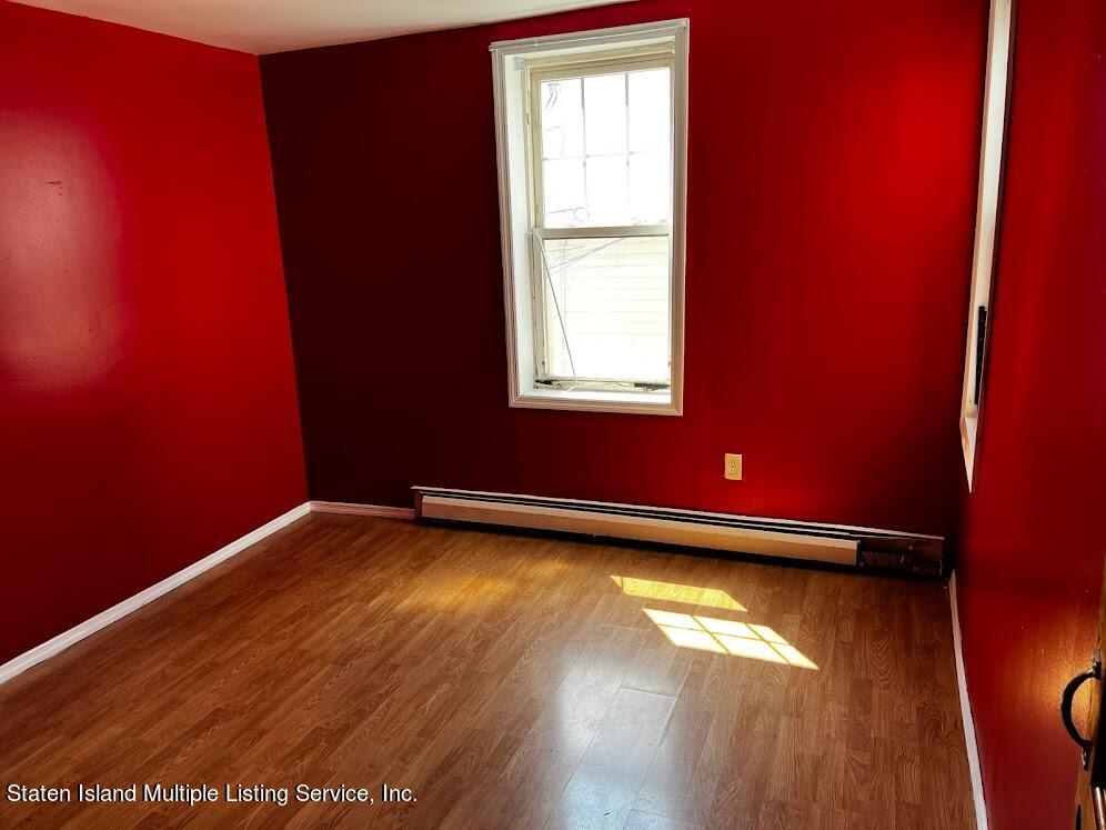 1641 Castleton Avenue Staten Island, NY 10302 - Photo 13 of 15 a view of empty room with wooden floor and fan