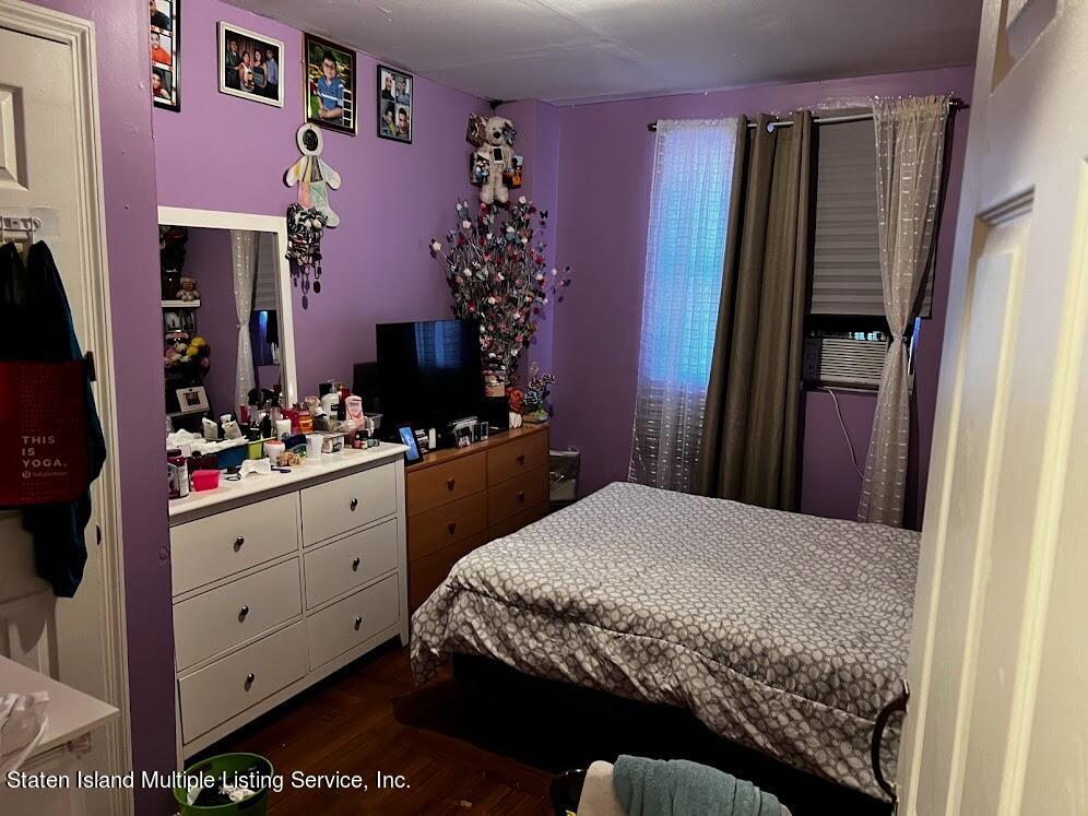 1641 Castleton Avenue Staten Island, NY 10302 - Photo 8 of 15 a bedroom with a bed and a dresser