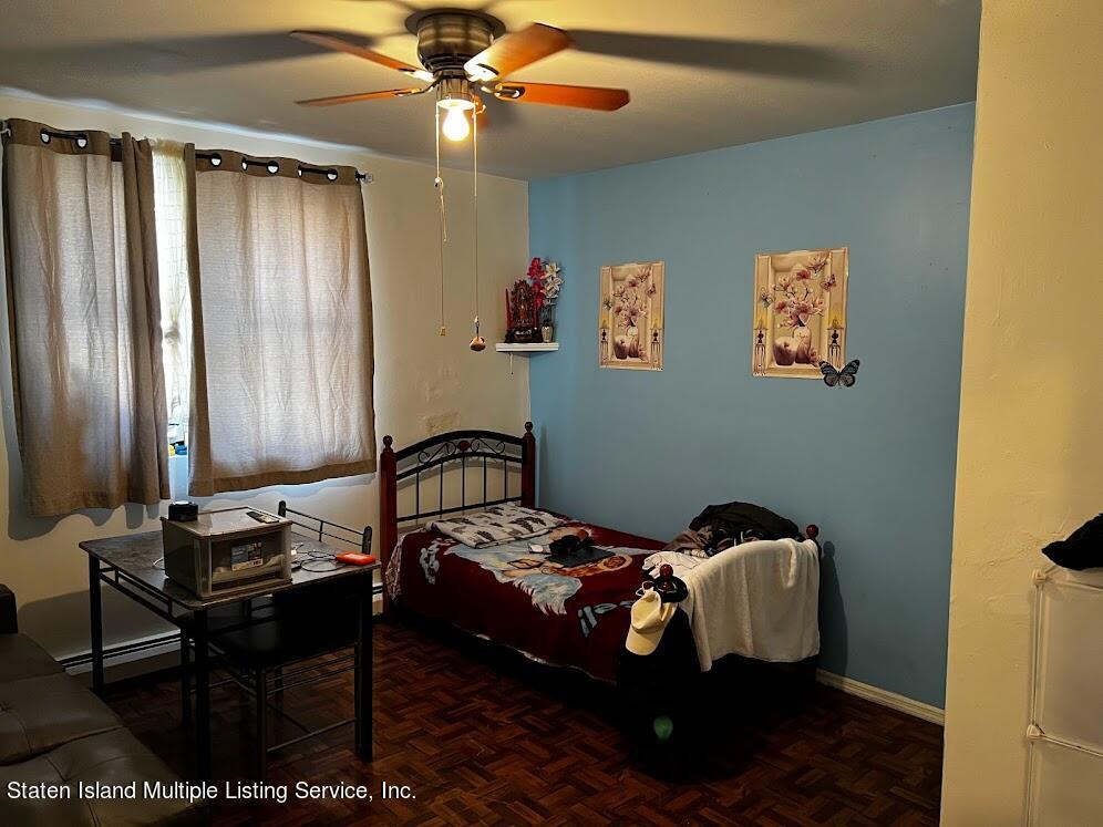 1641 Castleton Avenue Staten Island, NY 10302 - Photo 9 of 15 a bedroom with a bed and wooden floor
