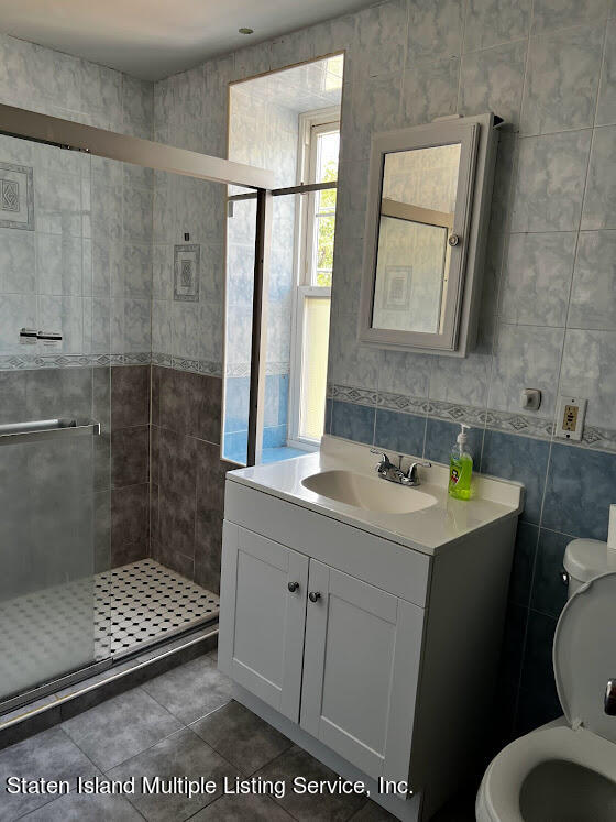 1641 Castleton Avenue Staten Island, NY 10302 - Photo 10 of 15 a bathroom with a sink a toilet and shower