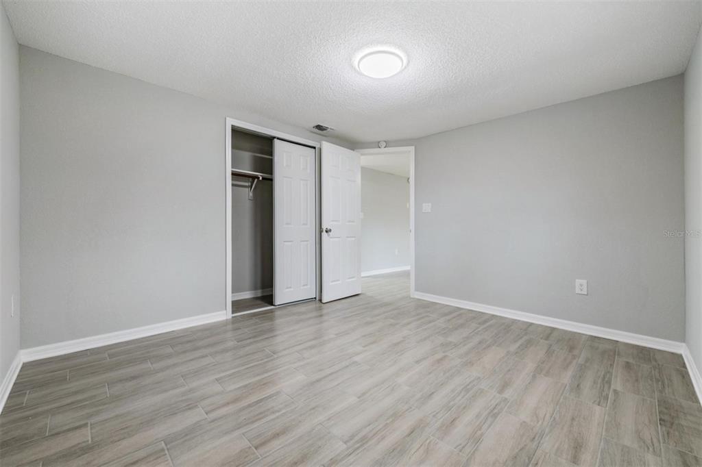 7806 Butler Avenue Hudson, FL 34667 - Photo 12 of 31 a view of an empty room with wooden floor