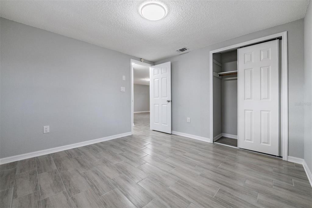 7806 Butler Avenue Hudson, FL 34667 - Photo 14 of 31 a view of an empty room with wooden floor