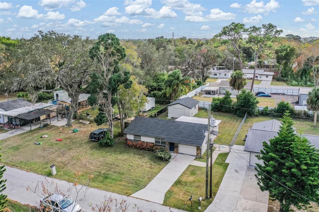 7806 Butler Avenue Hudson, FL 34667 - Photo 20 of 31 a aerial view of a house with a yard and lake view