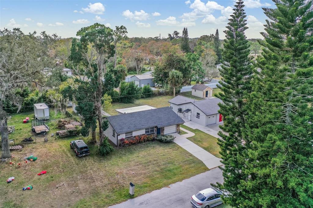 7806 Butler Avenue Hudson, FL 34667 - Photo 22 of 31 an aerial view of a house with swimming pool and garden