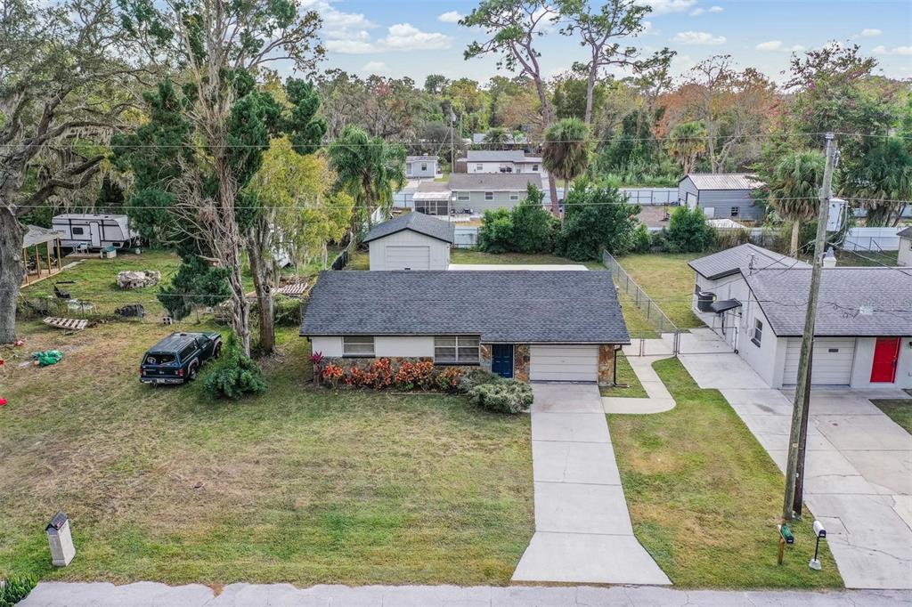 7806 Butler Avenue Hudson, FL 34667 - Photo 23 of 31 a aerial view of a house with swimming pool and large trees