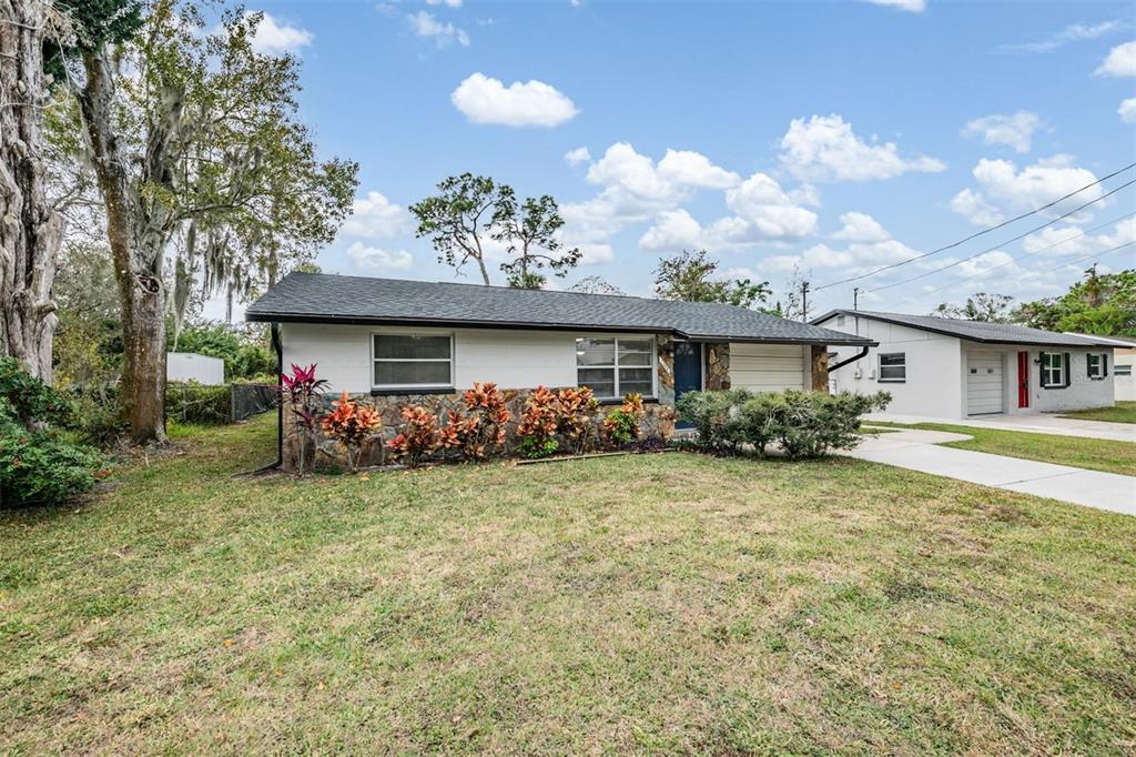7806 Butler Avenue Hudson, FL 34667 - Photo 28 of 31 a front view of a house with garden