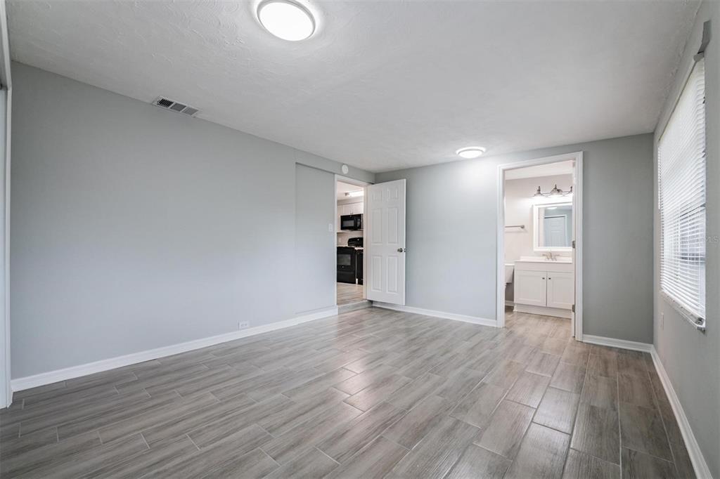 7806 Butler Avenue Hudson, FL 34667 - Photo 4 of 31 a view of an empty room with wooden floor and windows