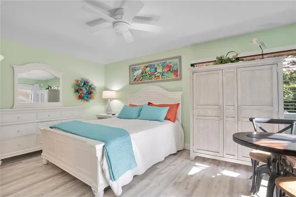 a spacious bedroom with a bed and a table in it