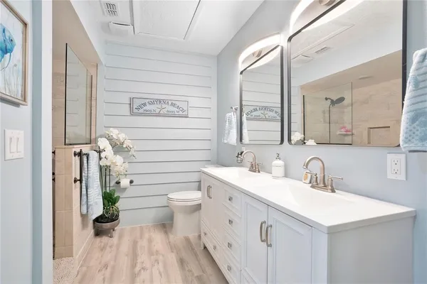 a bathroom with a sink a toilet and a mirror