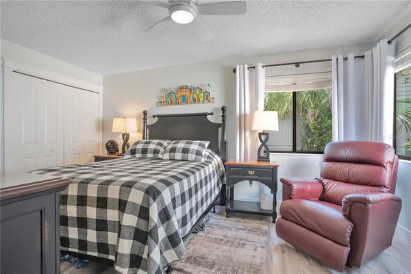 a bedroom with a bed and a couch