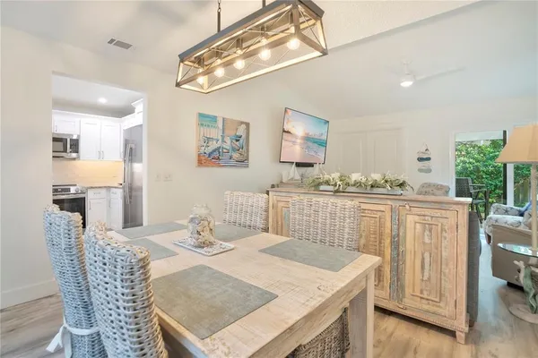 a view of a dining room with furniture and wooden floor