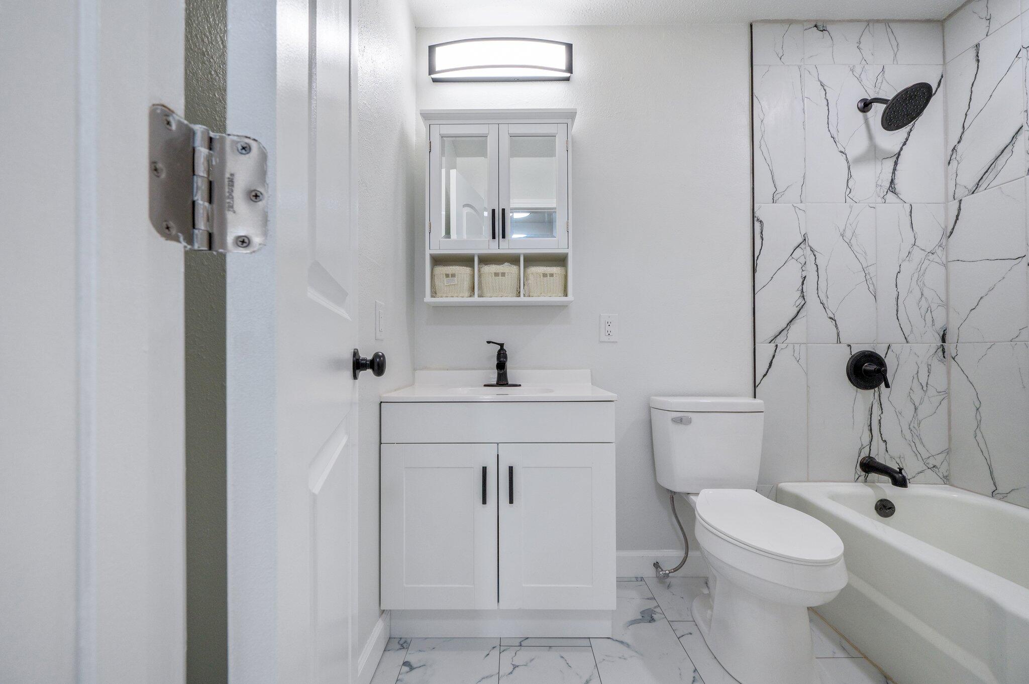 22543 Highway 331 Laurel Hill, FL 32567 - Photo 15 of 36 a bathroom with a sink a toilet and shower