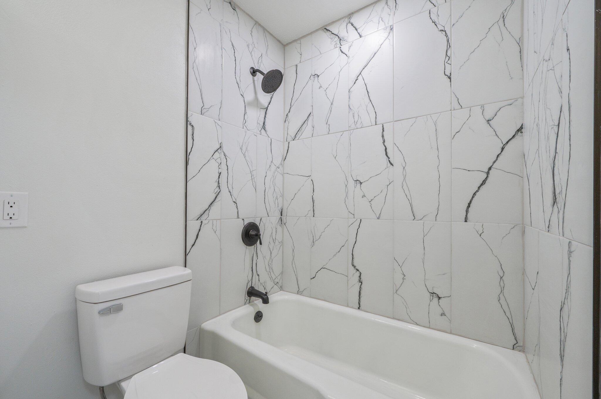 22543 Highway 331 Laurel Hill, FL 32567 - Photo 16 of 36 a white bath tub sitting next to a white toilet and sink