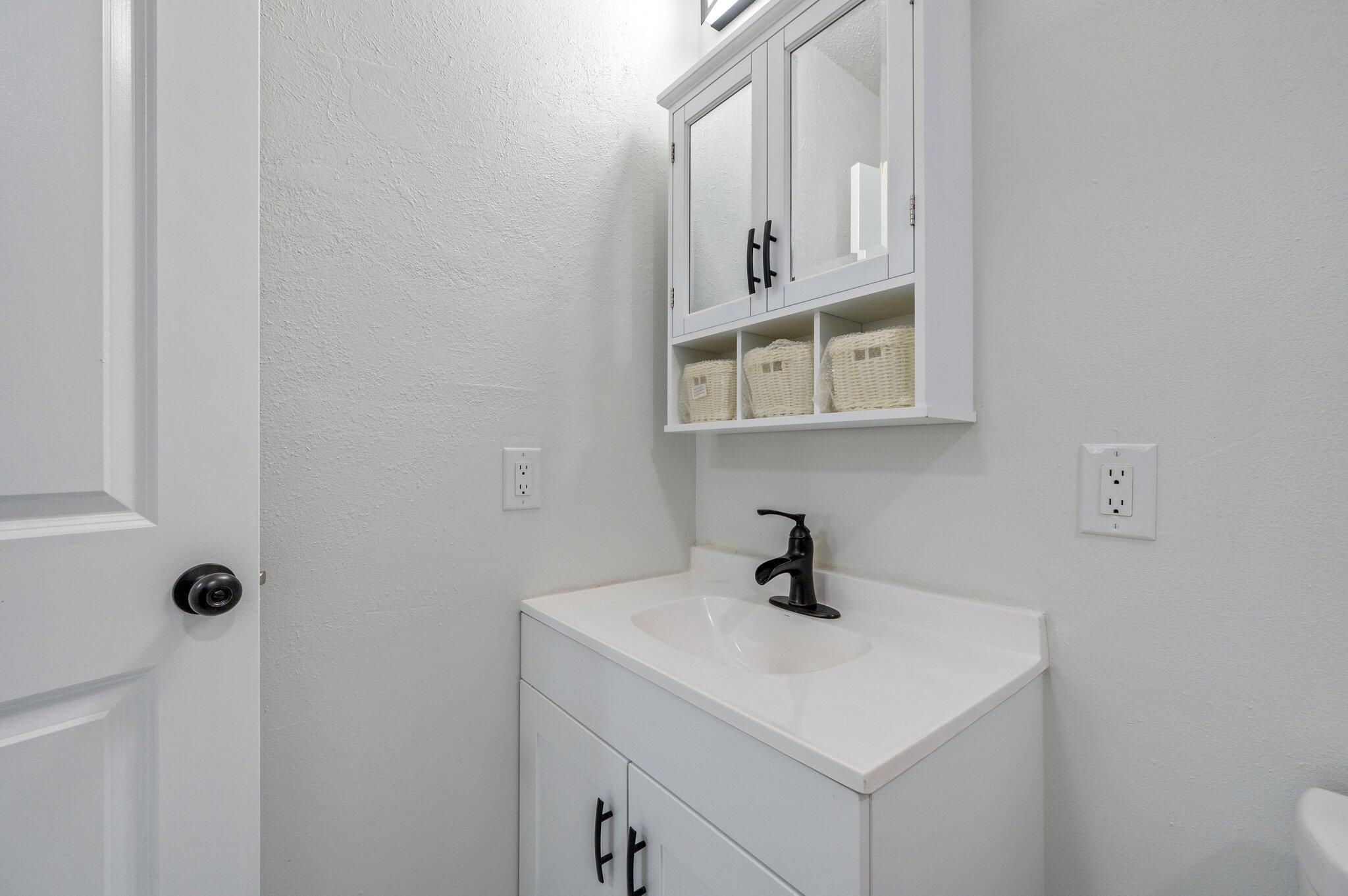 22543 Highway 331 Laurel Hill, FL 32567 - Photo 17 of 36 a bathroom with a sink and a mirror