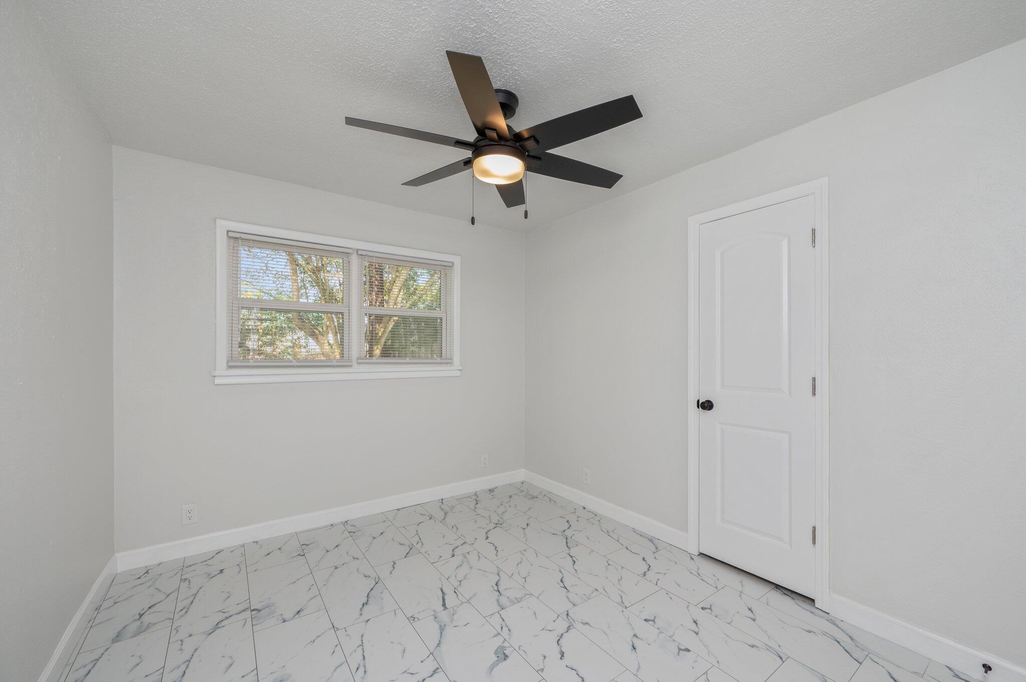 22543 Highway 331 Laurel Hill, FL 32567 - Photo 18 of 36 an empty room with ceiling fan and window