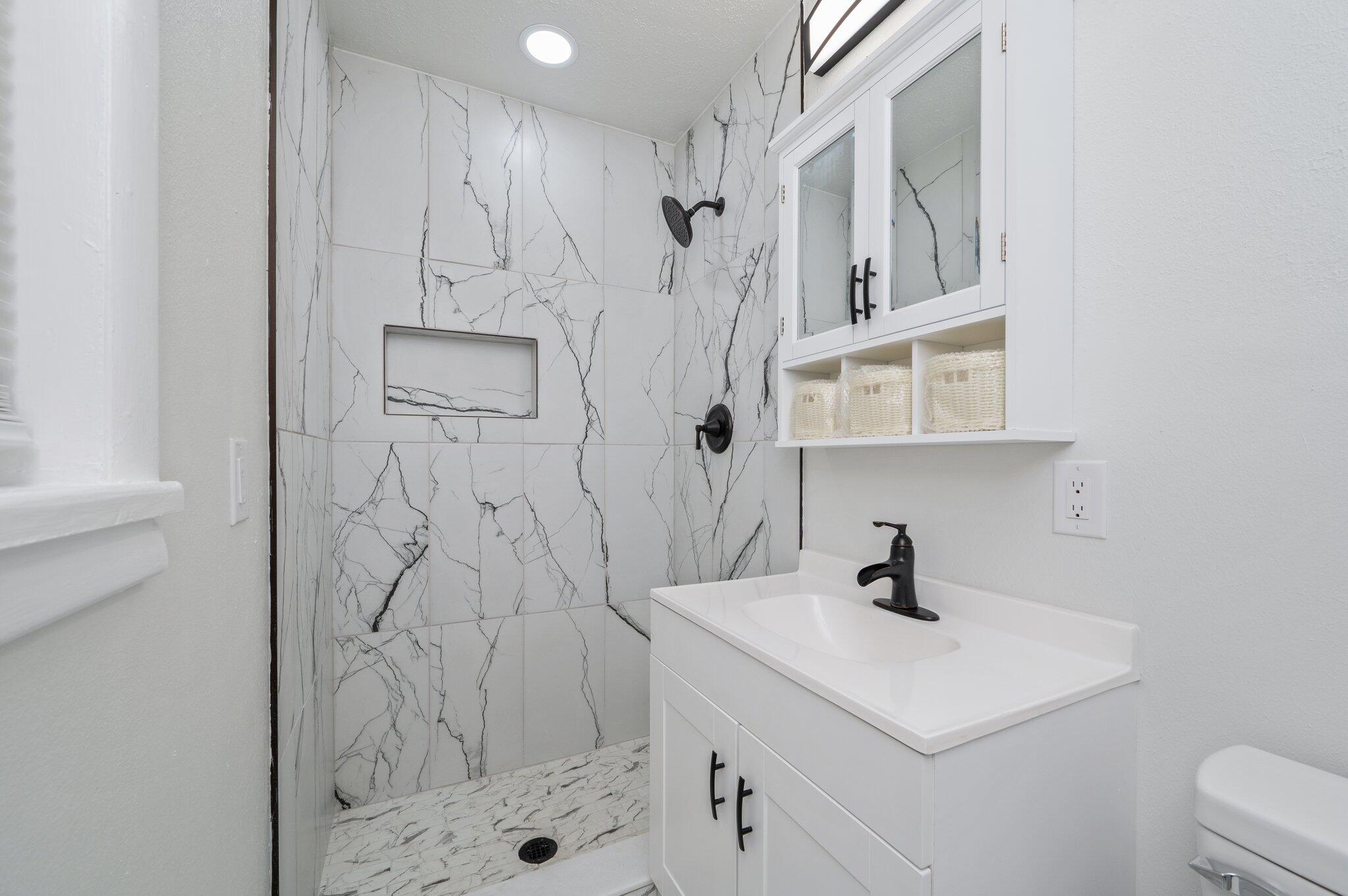 22543 Highway 331 Laurel Hill, FL 32567 - Photo 21 of 36 a bathroom with a sink a toilet and shower