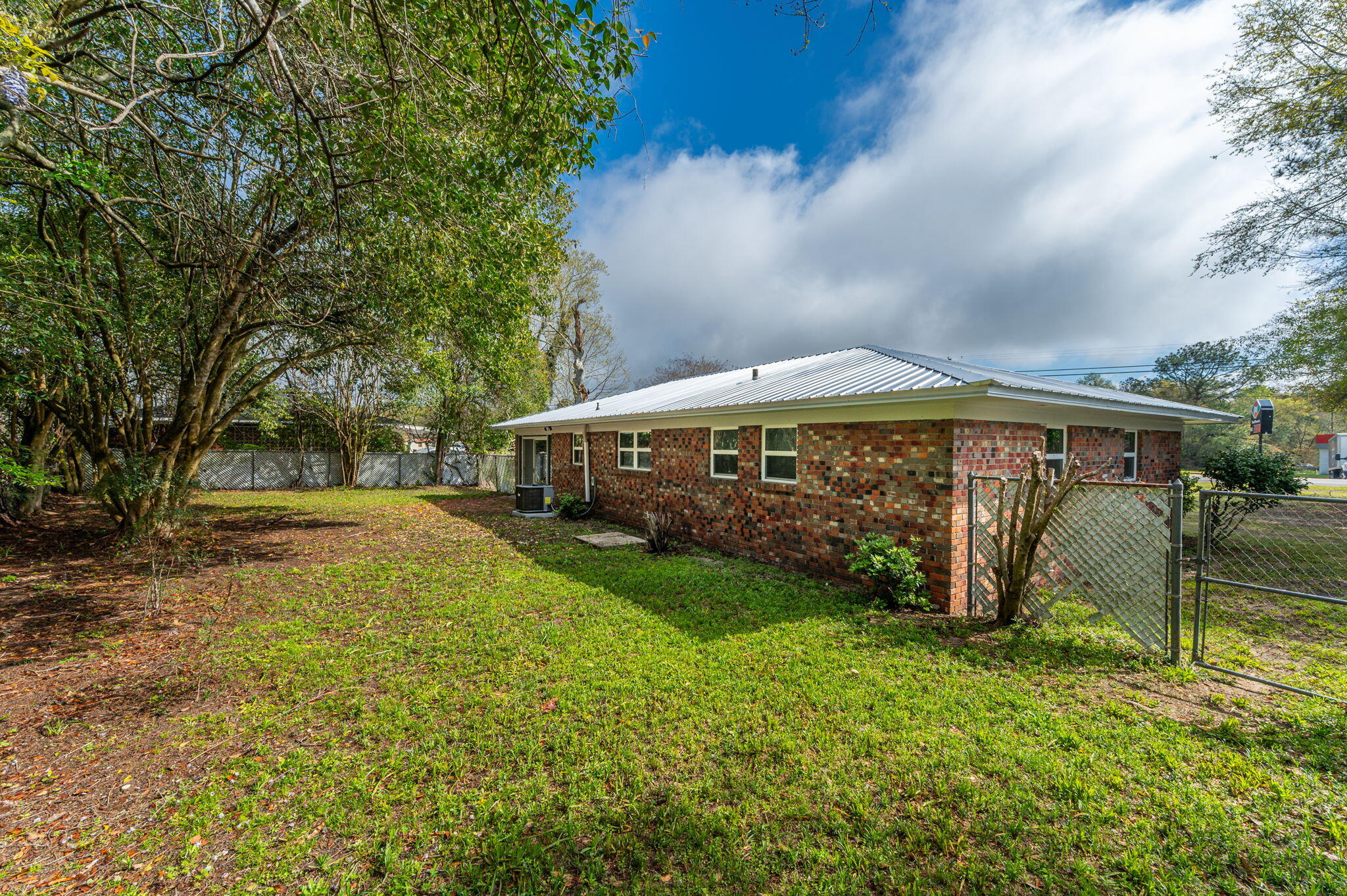 22543 Highway 331 Laurel Hill, FL 32567 - Photo 35 of 36 a front view of a house with garden