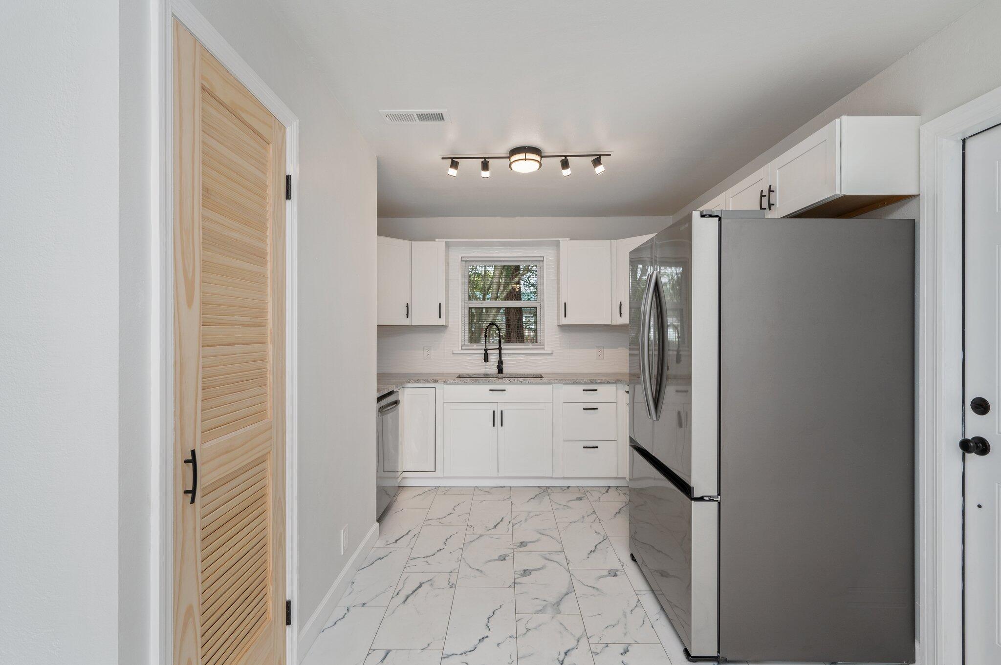 22543 Highway 331 Laurel Hill, FL 32567 - Photo 5 of 36 a kitchen with refrigerator and cabinets