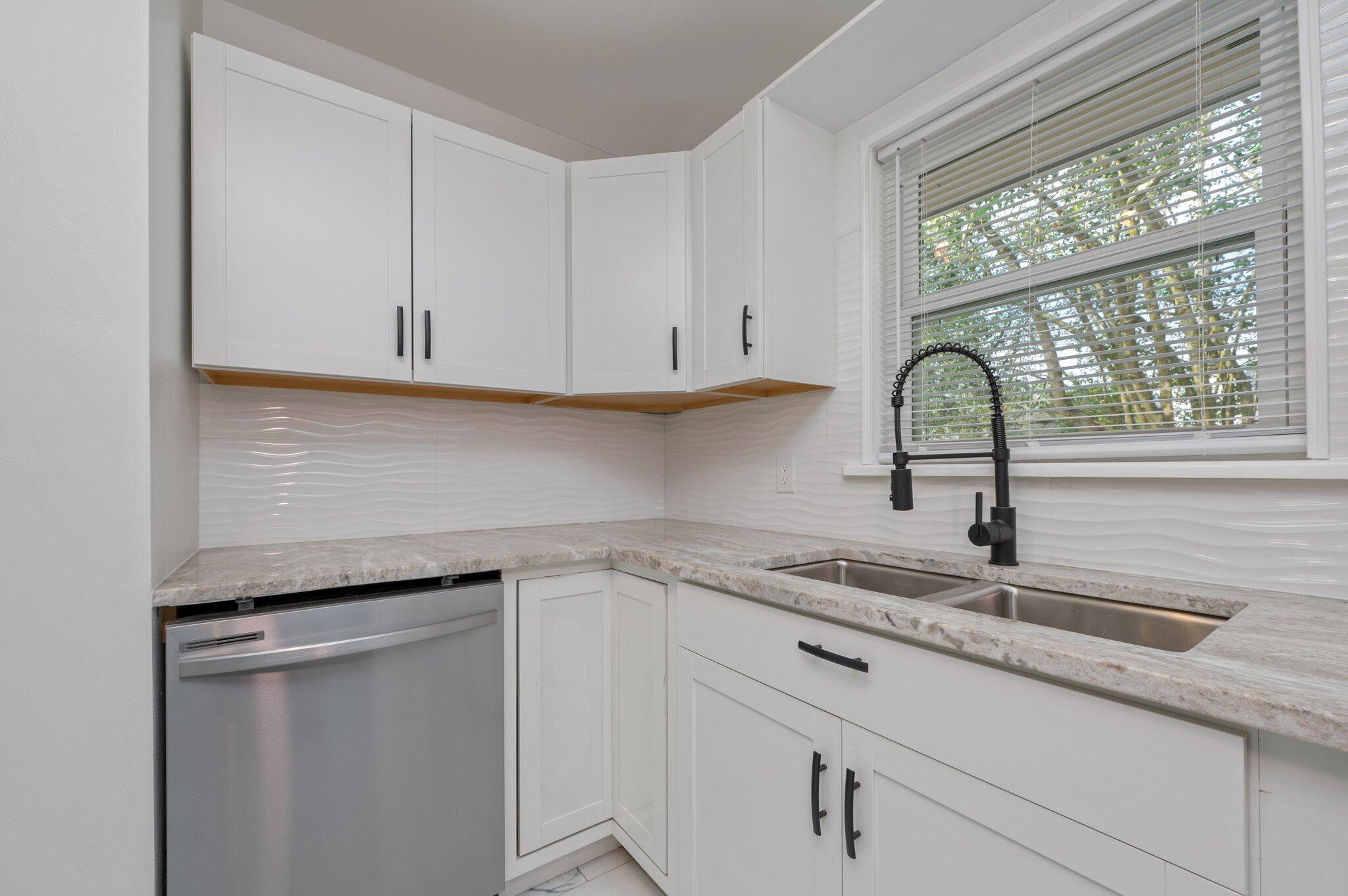 22543 Highway 331 Laurel Hill, FL 32567 - Photo 7 of 36 a kitchen with granite countertop white cabinets and a sink