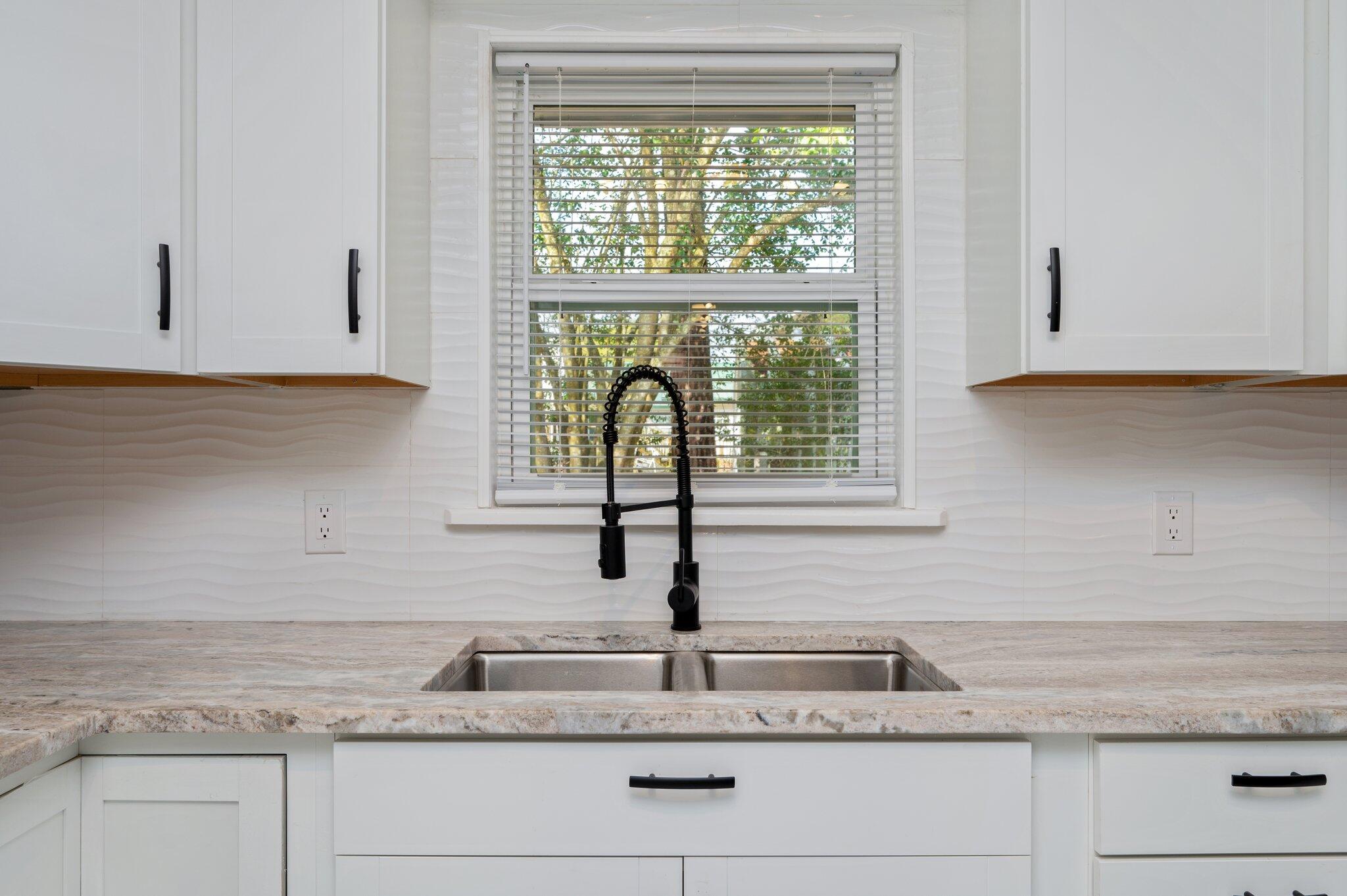 22543 Highway 331 Laurel Hill, FL 32567 - Photo 9 of 36 a kitchen with granite countertop white cabinets and a window
