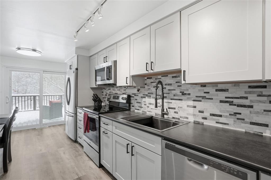 beautiful tile backsplash and soft-close drawers