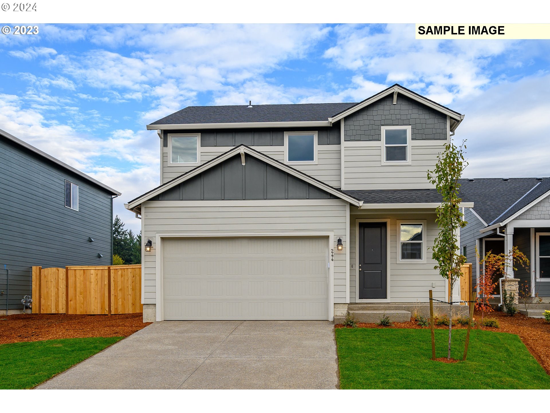 8719 North 3rd Street, Unit 39 Ridgefield, WA 98642 - Photo 1 of 21 a front view of a house with a yard and garage