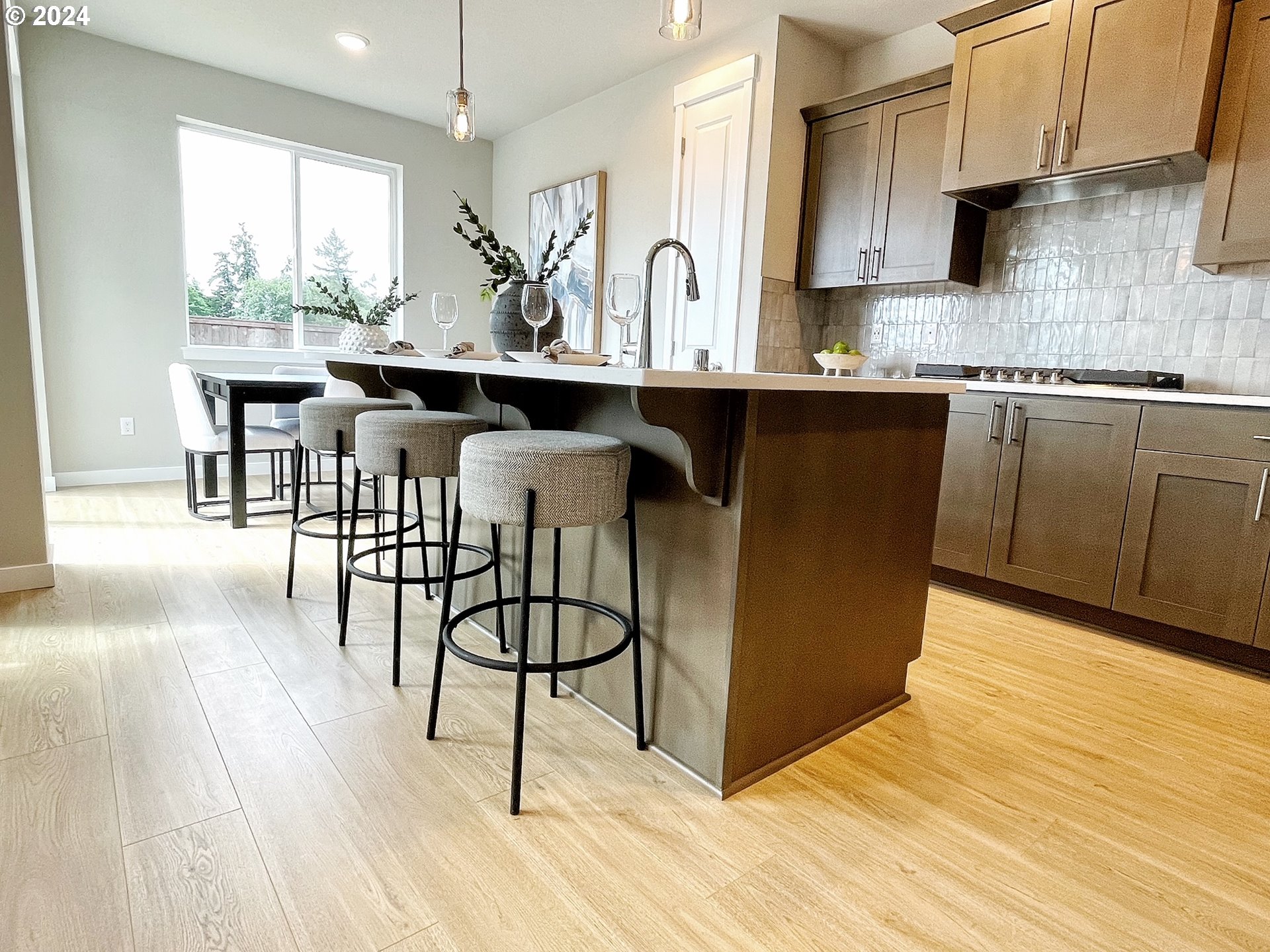 8719 North 3rd Street, Unit 39 Ridgefield, WA 98642 - Photo 9 of 21 a kitchen with stainless steel appliances kitchen island granite countertop a sink cabinets and wooden floor