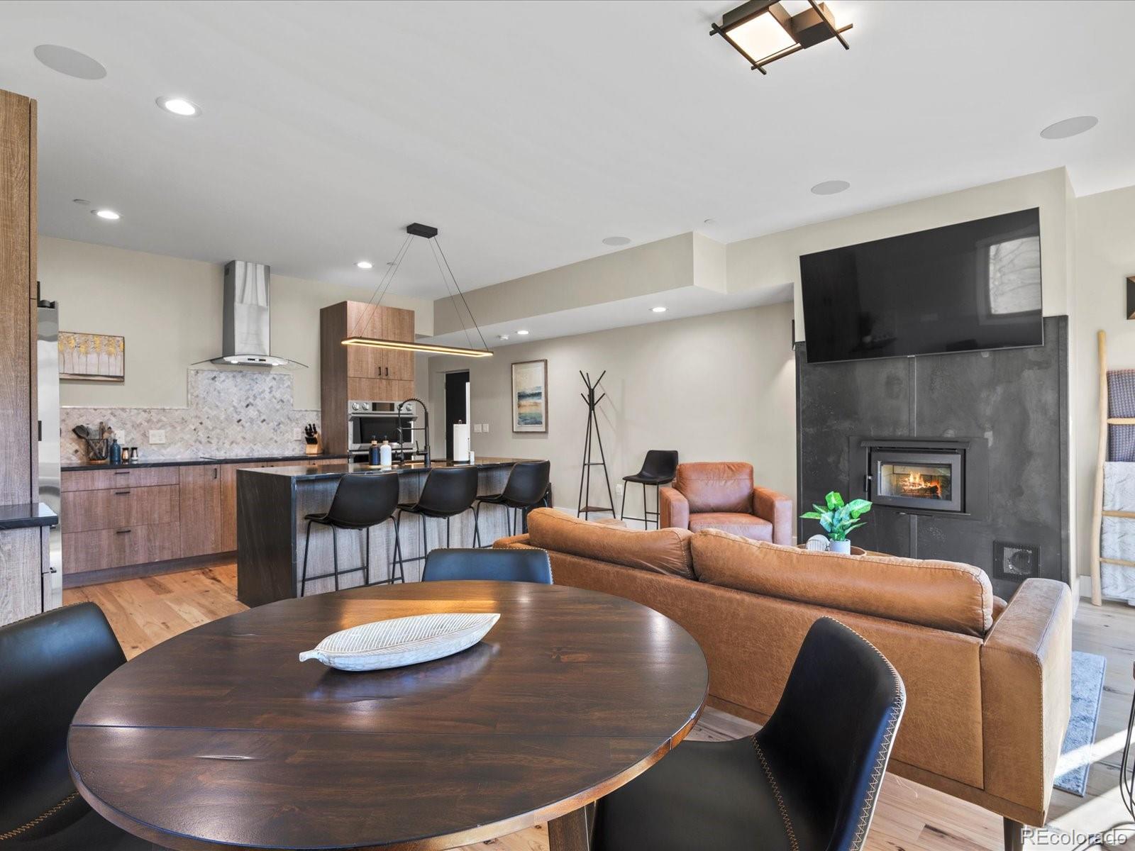 718 Emerson Gulch Road Boulder, CO 80302 - Photo 11 of 42 a living room with furniture and a fireplace