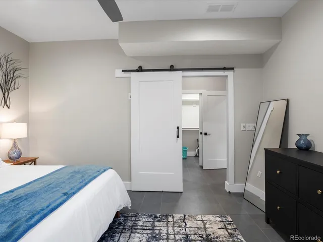 a bathroom with a granite countertop sink a toilet and shower