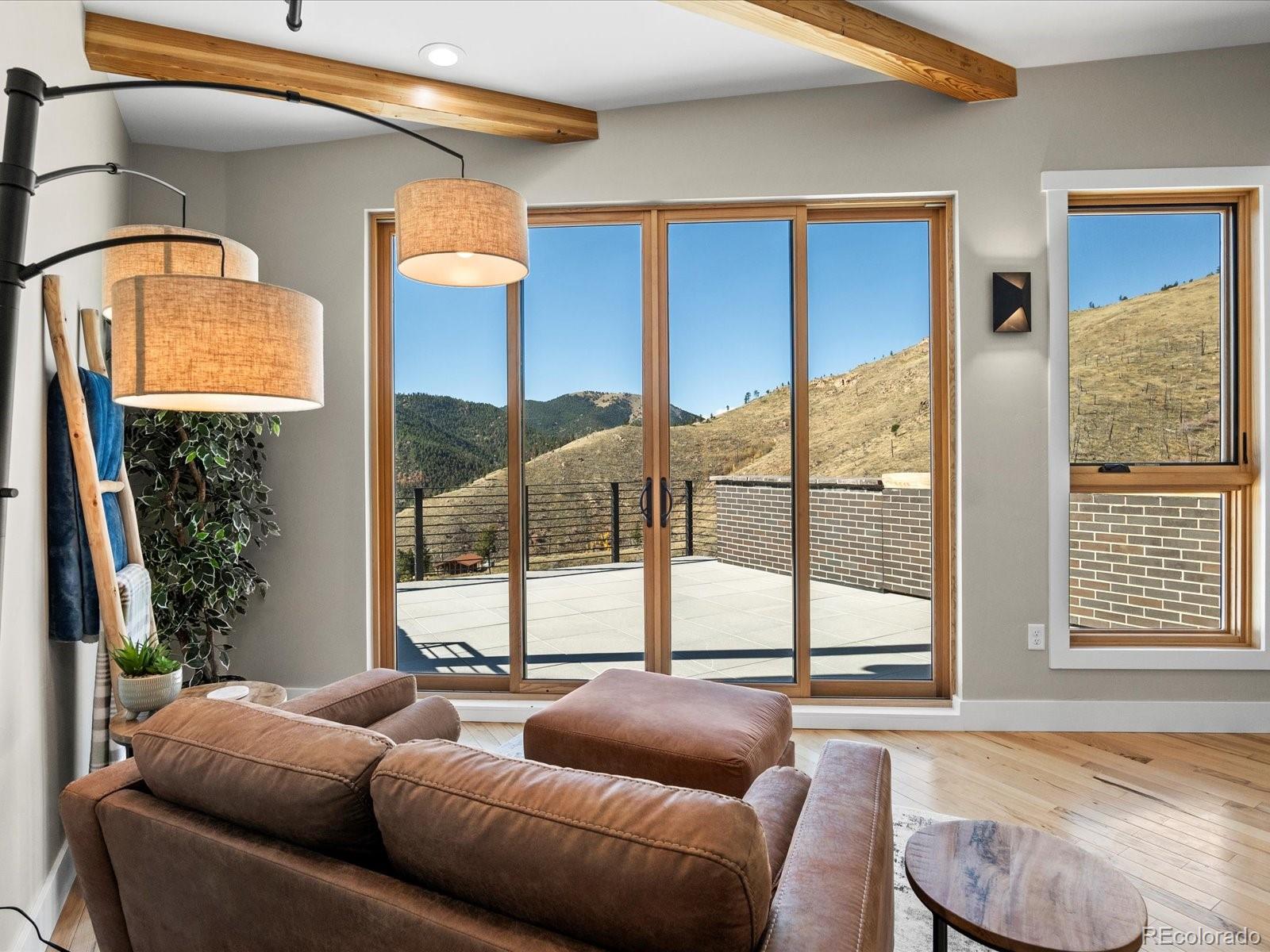 718 Emerson Gulch Road Boulder, CO 80302 - Photo 31 of 42 a living room with furniture and a floor to ceiling window