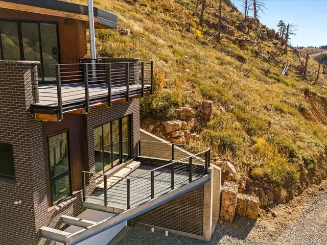 a roof deck with table and chairs