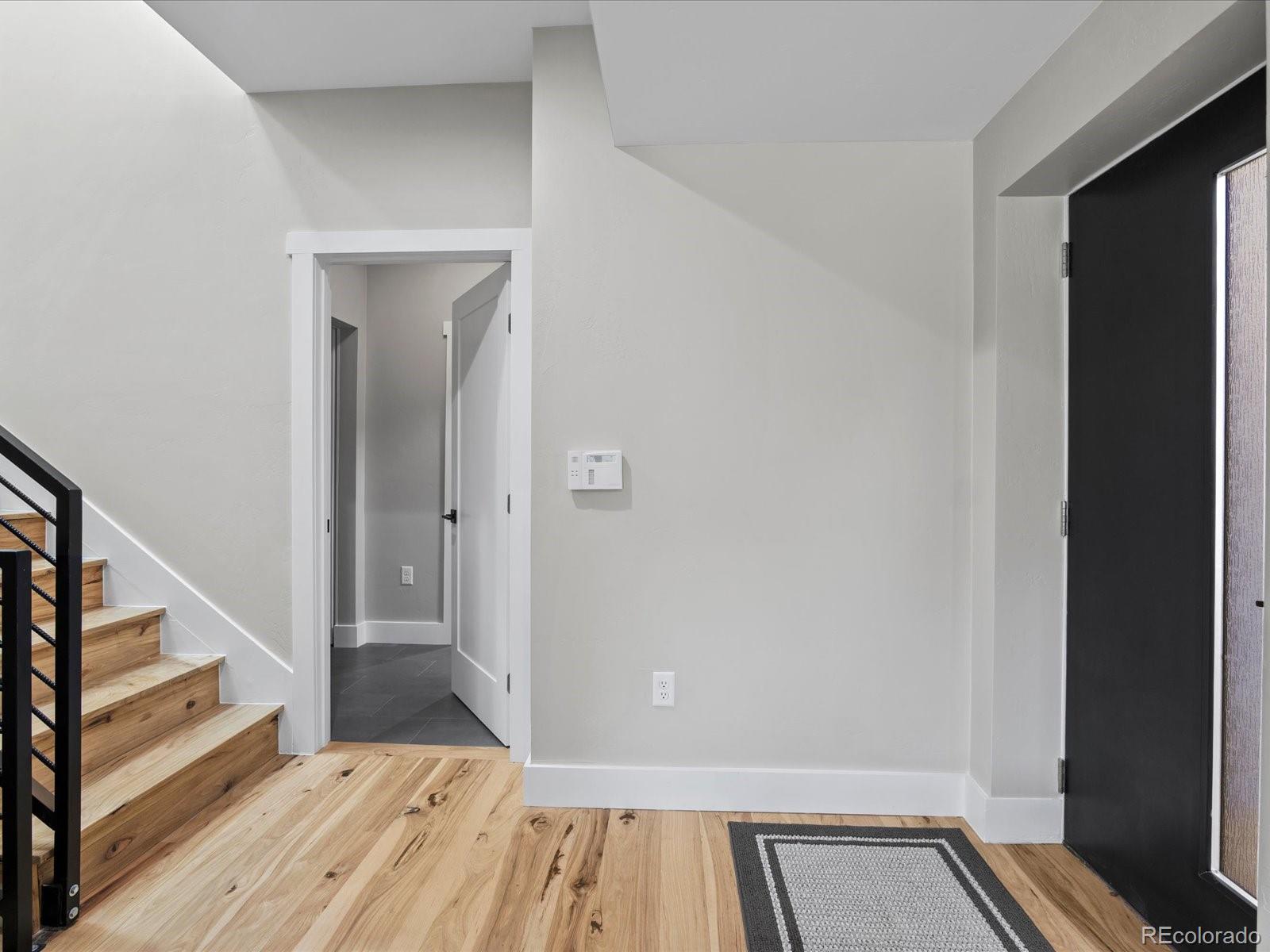 718 Emerson Gulch Road Boulder, CO 80302 - Photo 4 of 42 a view of a hallway view with wooden floor and staircase