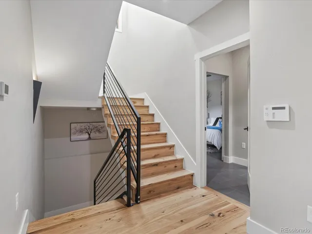 a view of entryway and hall with wooden floor