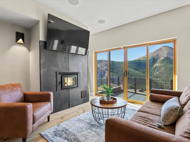 a living room with furniture and a floor to ceiling window