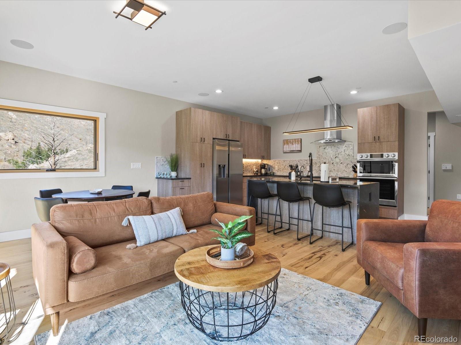 718 Emerson Gulch Road Boulder, CO 80302 - Photo 9 of 42 a living room with furniture kitchen and a table