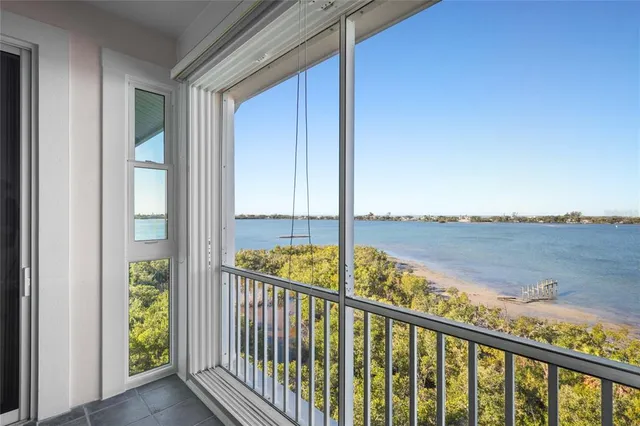 a kitchen with kitchen island white cabinets and stainless steel appliances