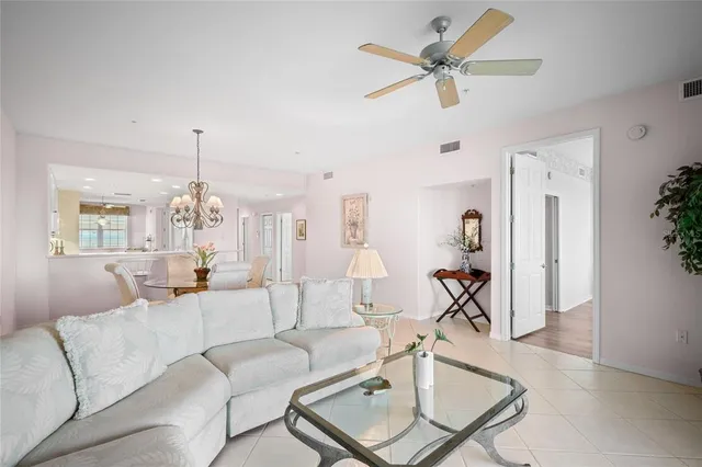 a kitchen with a sink dishwasher and white cabinets with wooden floor
