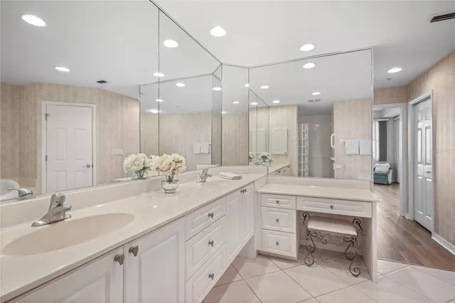 a view of swimming pool with seating yard and trees in the background