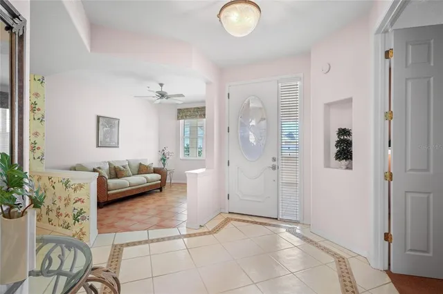 a living room with furniture and a potted plant