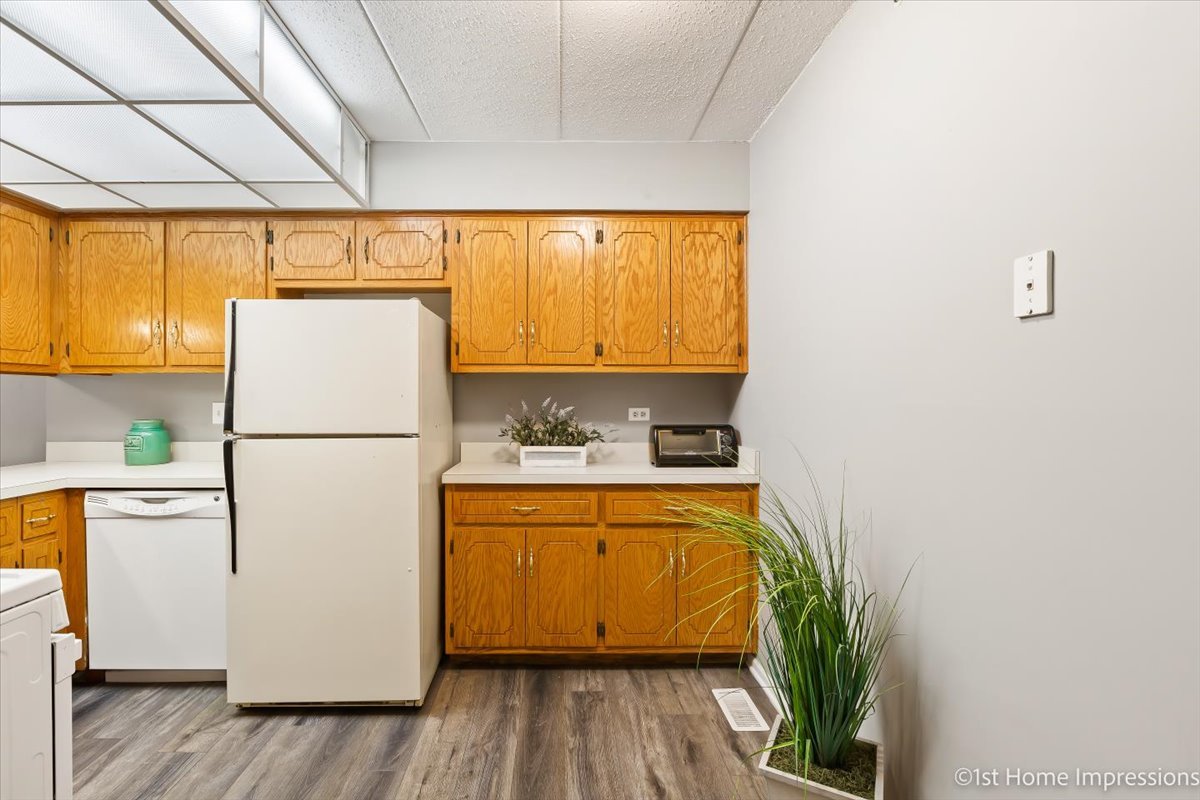 10626 Ridgeland Avenue, Unit 1B Chicago Ridge, IL 60415 - Photo 8 of 23 a white refrigerator freezer sitting inside of a kitchen