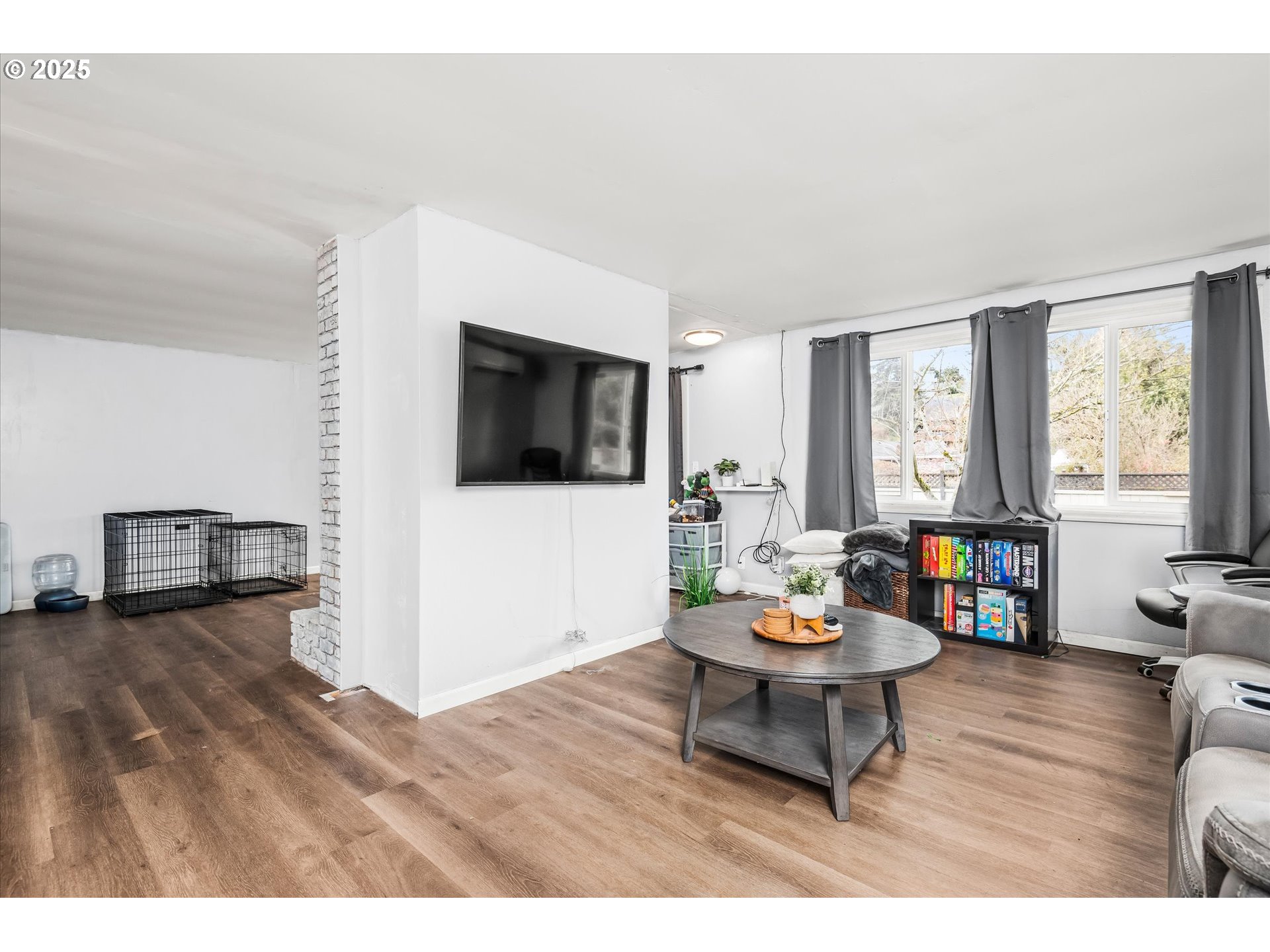 1310 Corum Avenue Eugene, OR 97401 - Photo 11 of 28 a living room with furniture a dining table and a fireplace with wooden floor