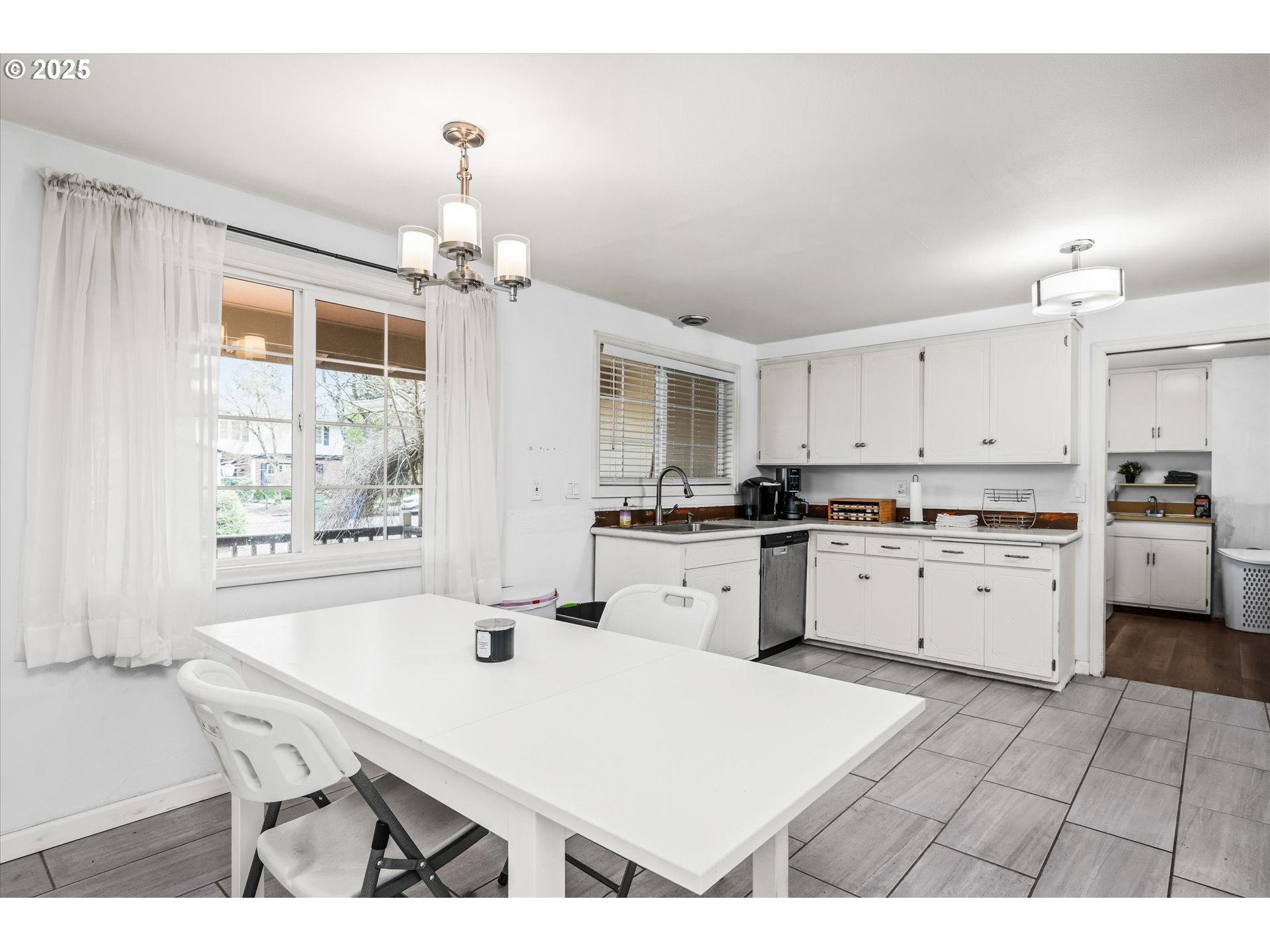 1310 Corum Avenue Eugene, OR 97401 - Photo 12 of 28 a kitchen with a table chairs stove and cabinets