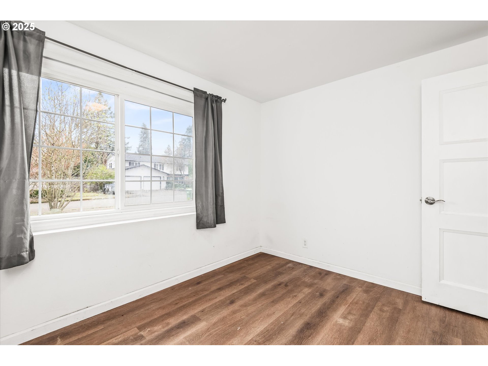 1310 Corum Avenue Eugene, OR 97401 - Photo 22 of 28 a view of an empty room with wooden floor and a window