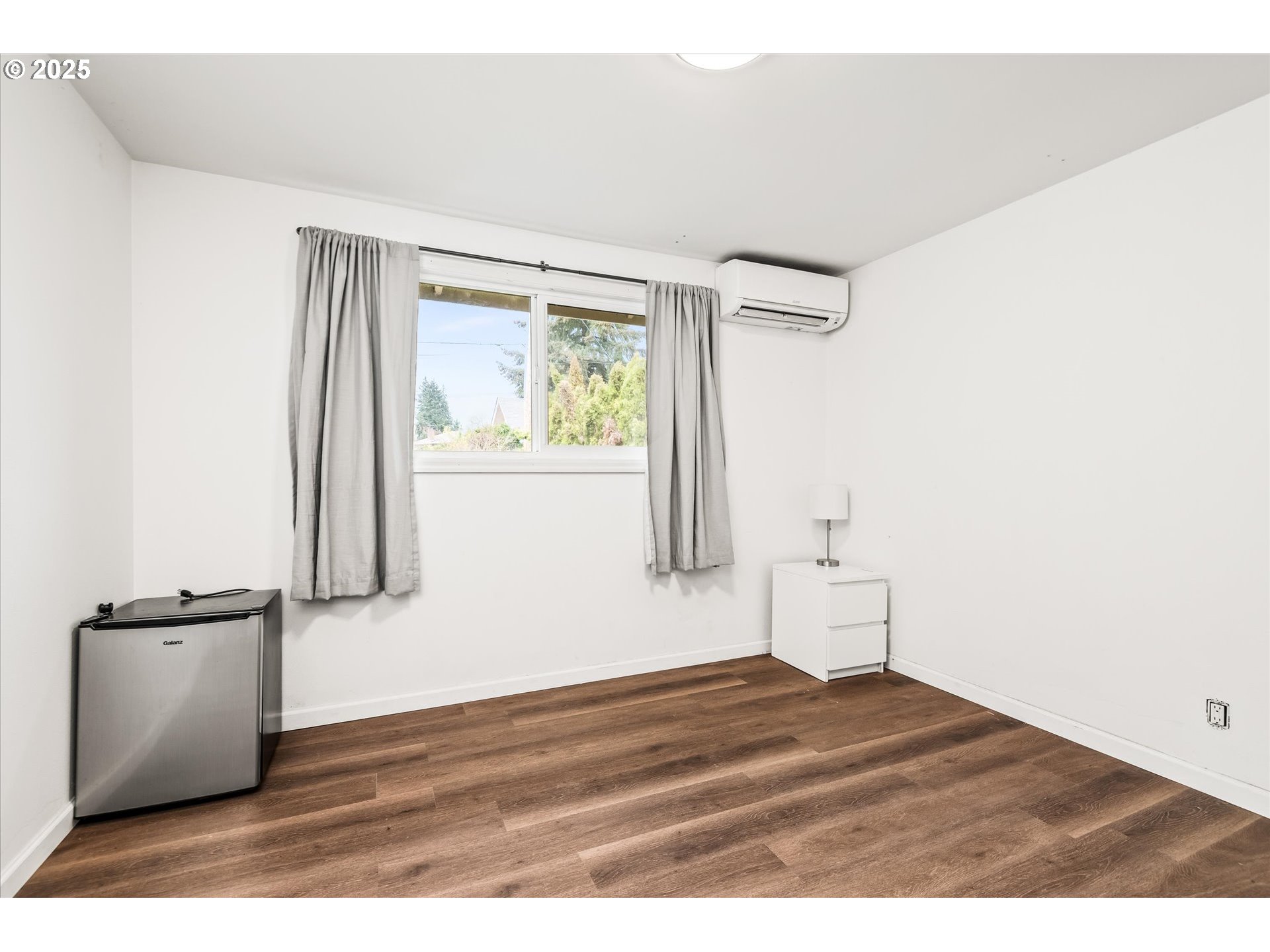 1310 Corum Avenue Eugene, OR 97401 - Photo 23 of 28 a view of empty room with wooden floor and fan
