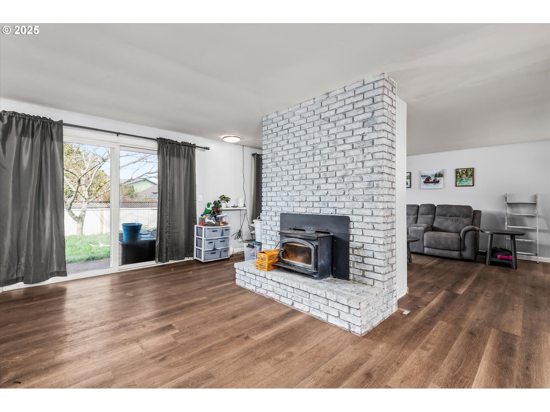 1310 Corum Avenue Eugene, OR 97401 - Photo 6 of 28 a living room with furniture and a fireplace