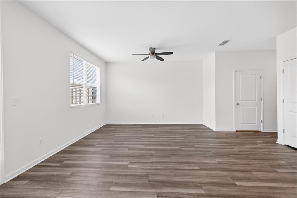 64 Thetford Way Winder, GA 30680 - Photo 12 of 41 a view of a room with wooden floor and a ceiling fan