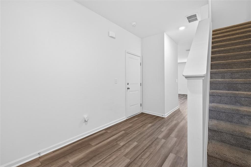 64 Thetford Way Winder, GA 30680 - Photo 14 of 41 a view of a room with wooden floor and white walls