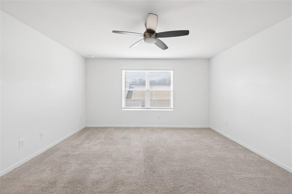 64 Thetford Way Winder, GA 30680 - Photo 16 of 41 an empty room with a window and a fan